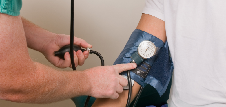 Person wearing blood pressure monitor